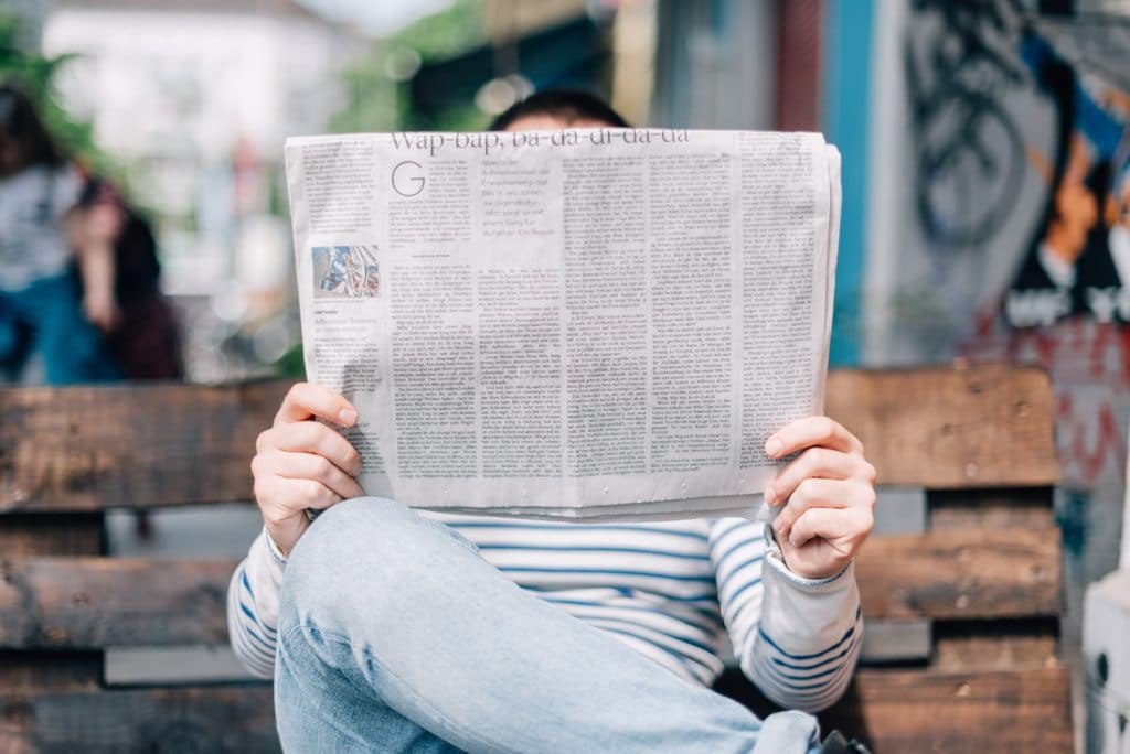 Person reading newspaper